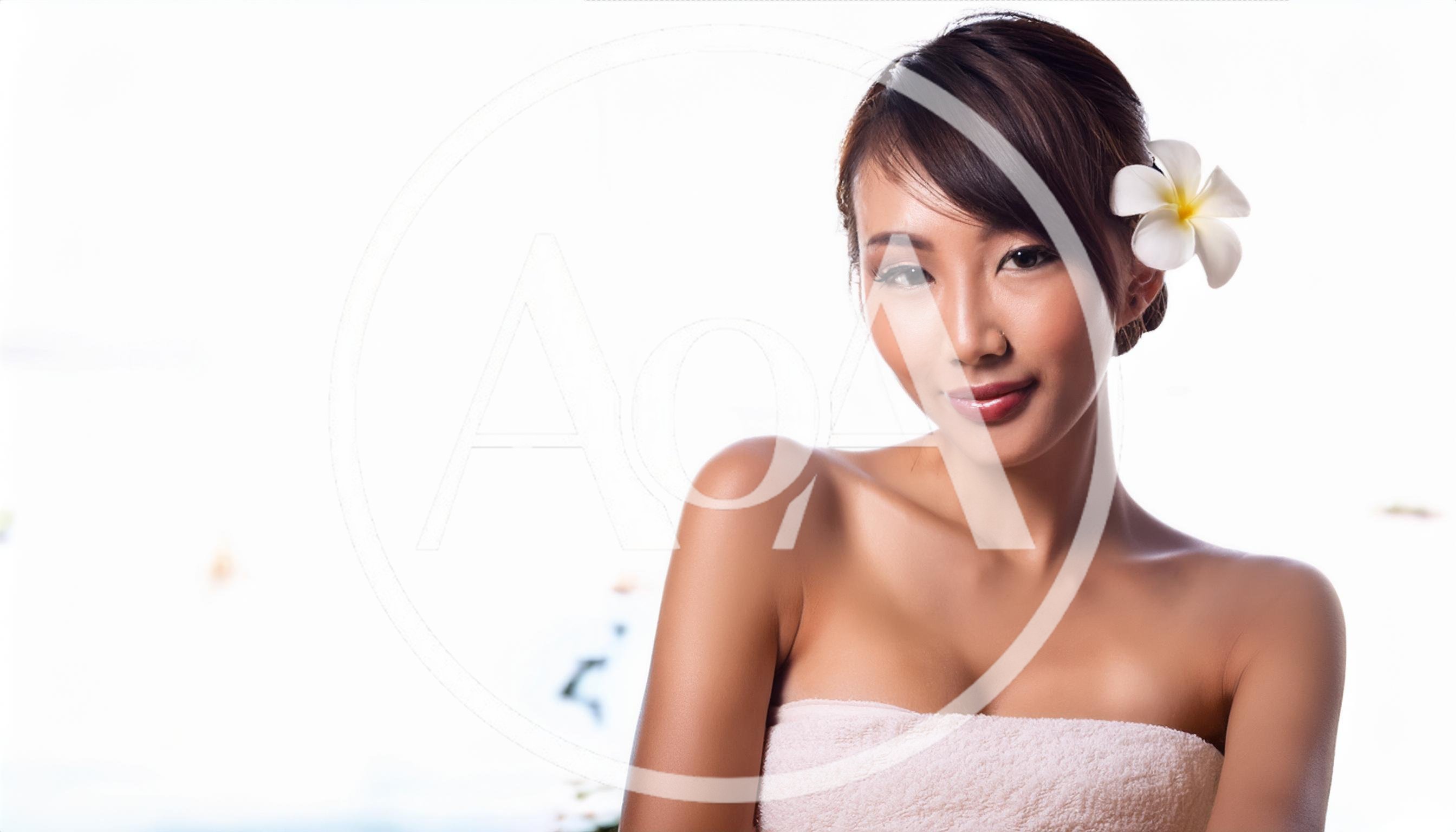 Beautiful Asian Woman With A Plumeria Flower In Hair