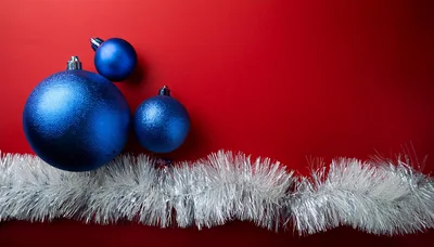 Blue Christmas Ornaments With Silver Tinsel On Red Background