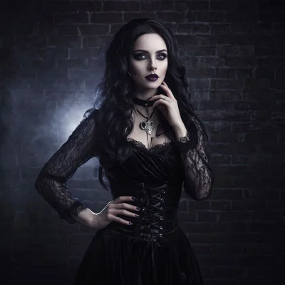Gothic Woman Posing Against A Dark Brick Wall