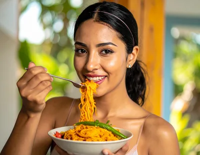 Young Woman Eating Spicy Noodles From A Bowl