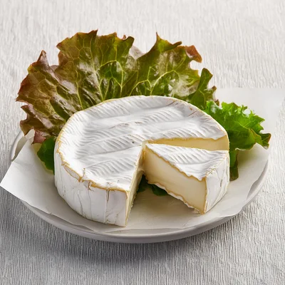 Wheel Of Brie Cheese With A Cut Slice