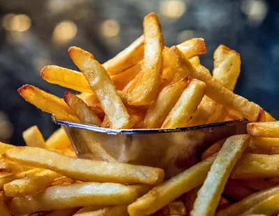 Golden Crispy French Fries In A Metal Cup
