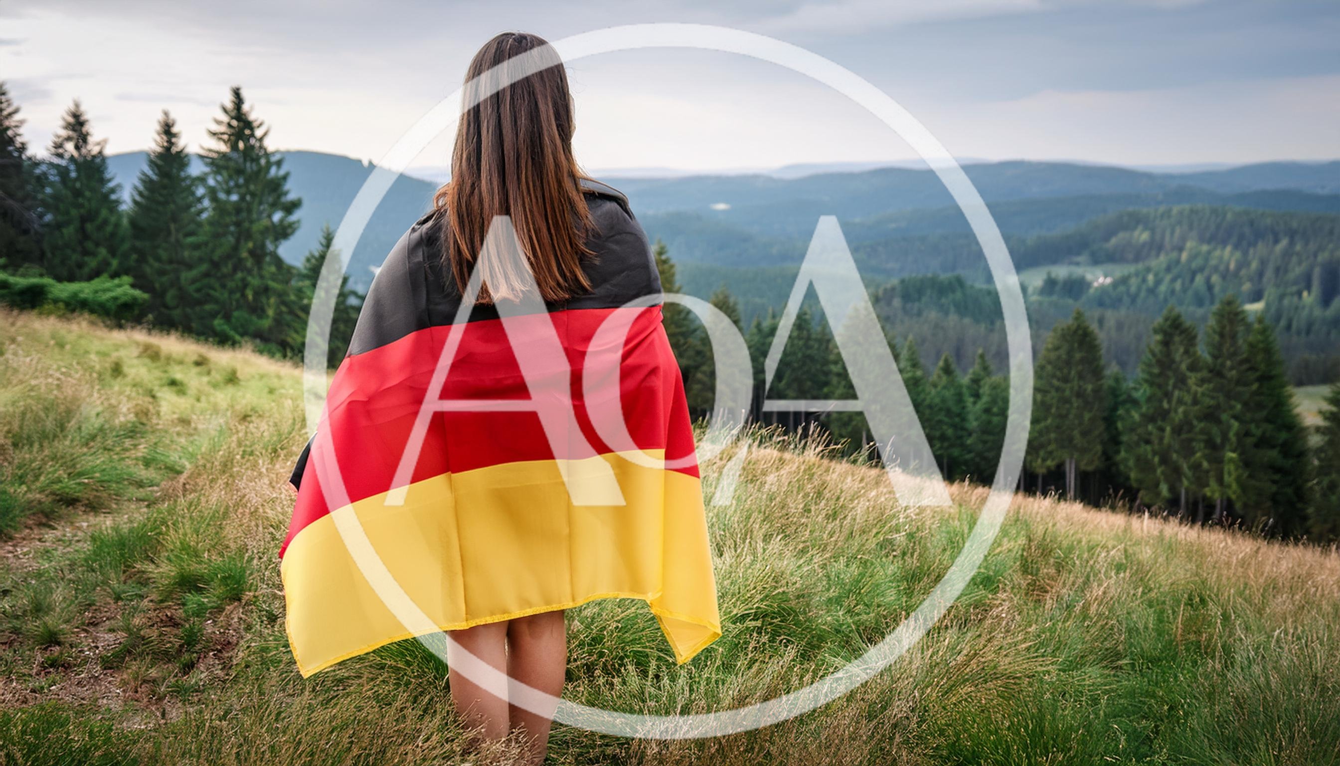 Woman Standing On Hillside Wrapped In German Flag