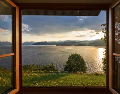 Scenic View Of A Lake At Sunset Through An Open Window