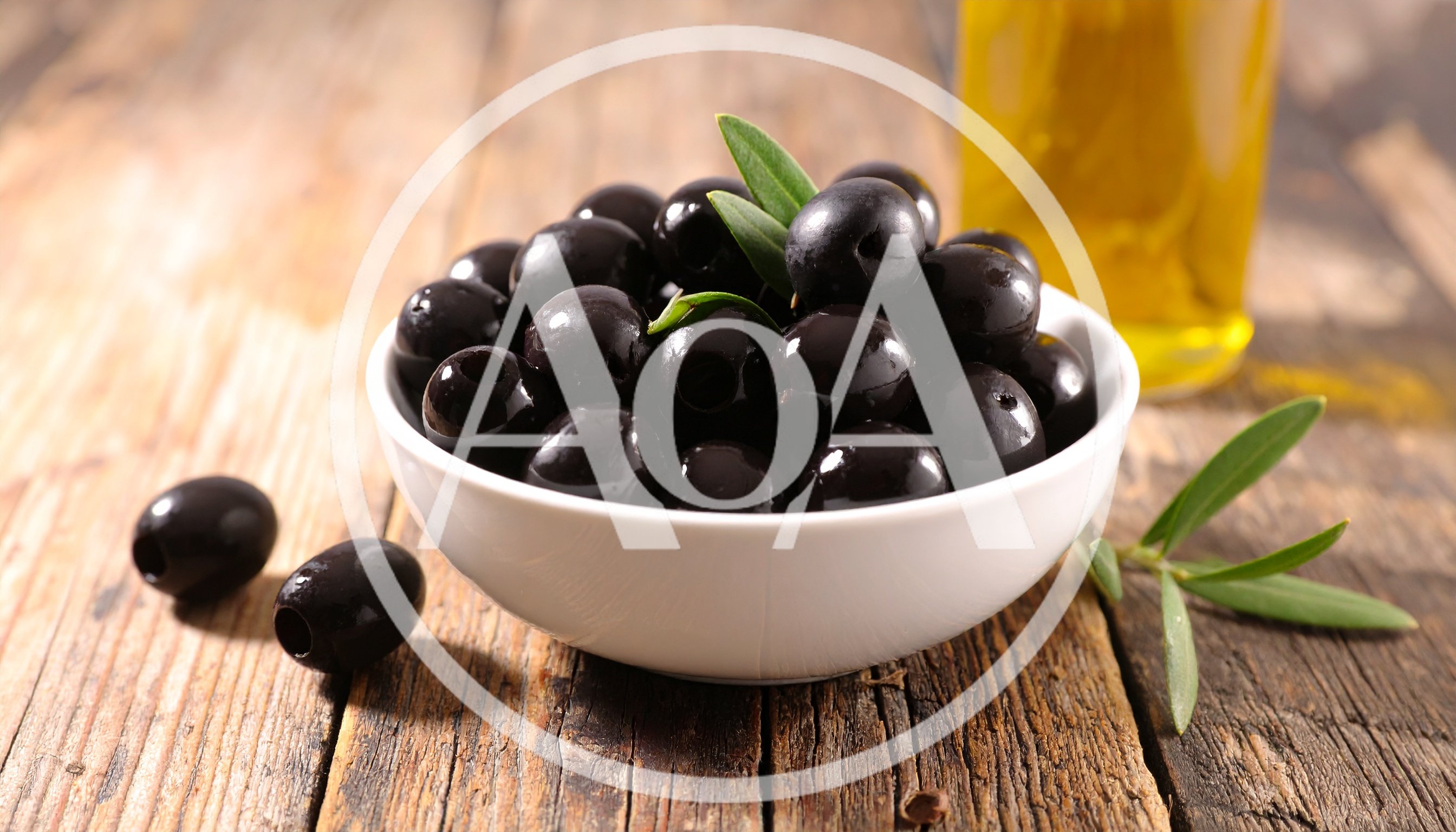 Black Olives in a White Bowl on Wooden Table