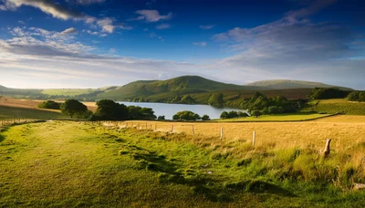Rolling Green Hills And Lake In The English Countryside