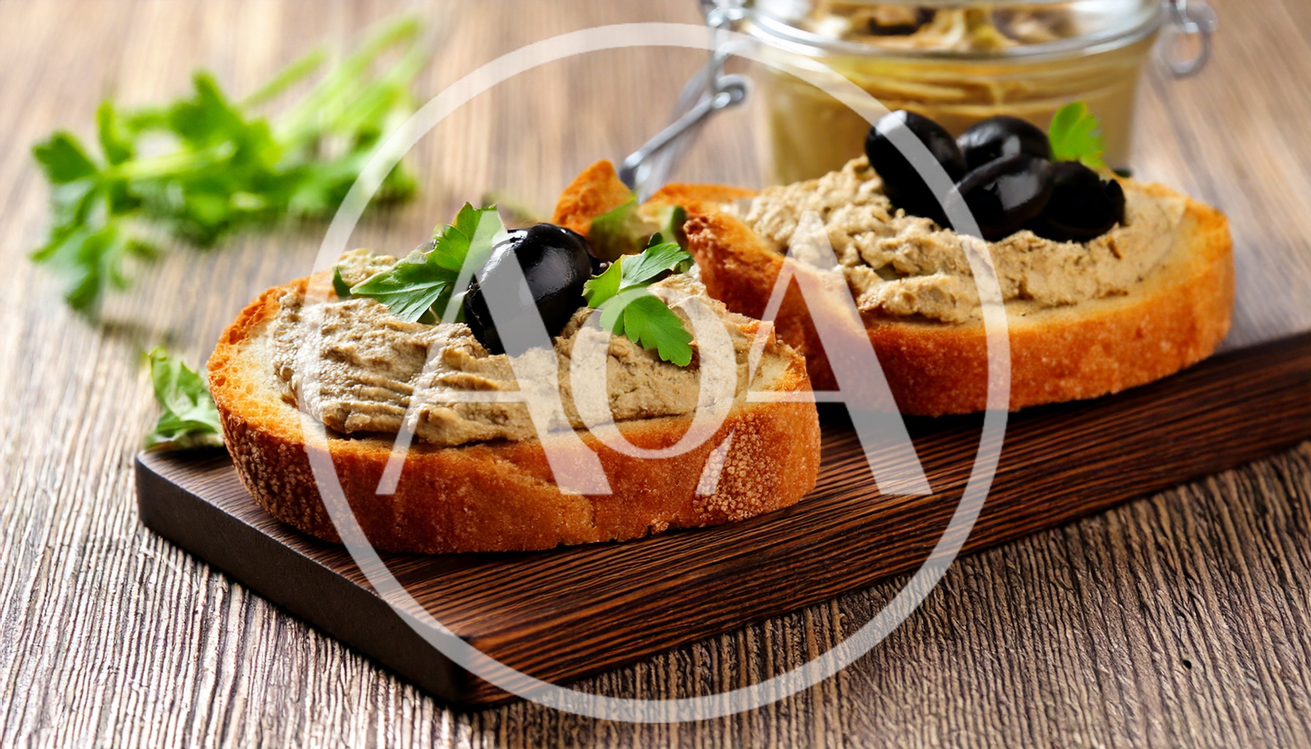 Two Slices Of Toasted Bread With Pate And Olives
