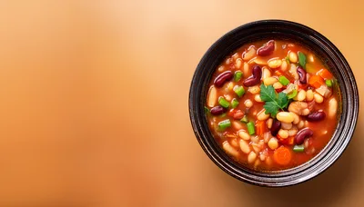 Bowl Of Hearty Bean Soup On Orange Background