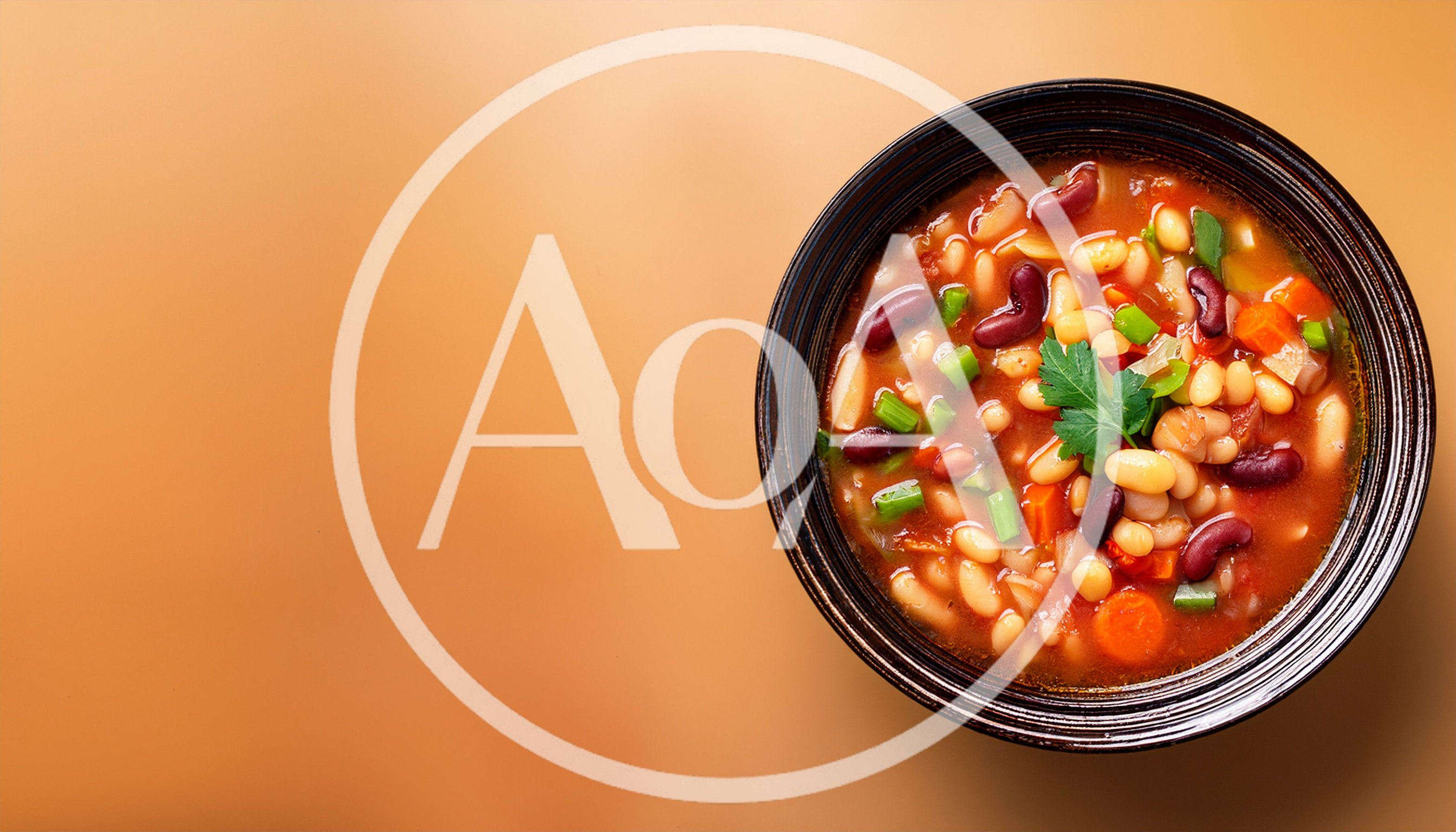 Bowl Of Hearty Bean Soup On Orange Background