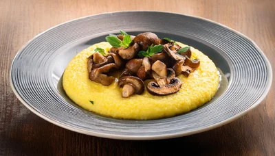 Creamy Polenta With Sautéed Mushrooms On A Plate