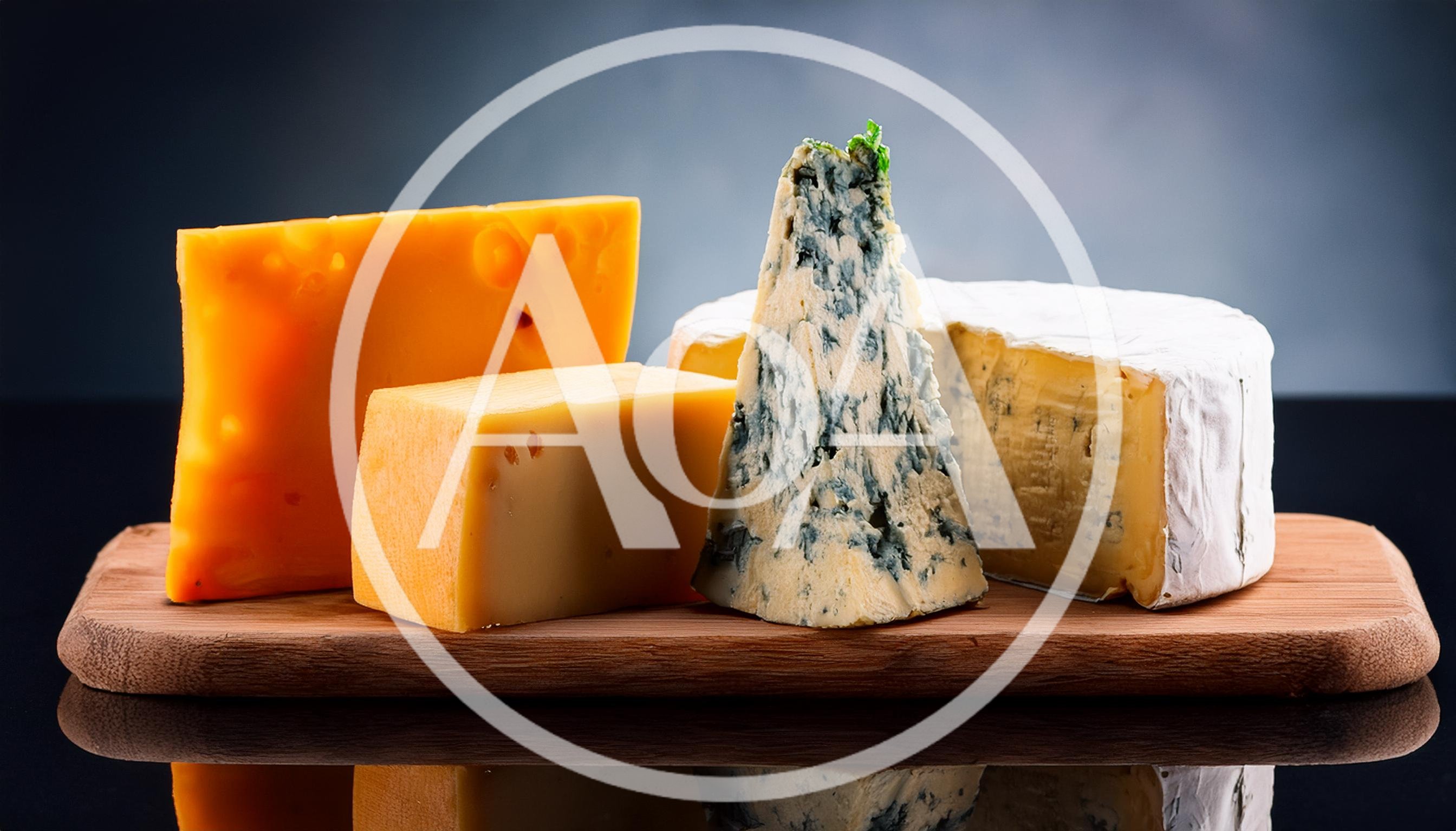 Assorted Gourmet Cheeses On A Wooden Serving Board