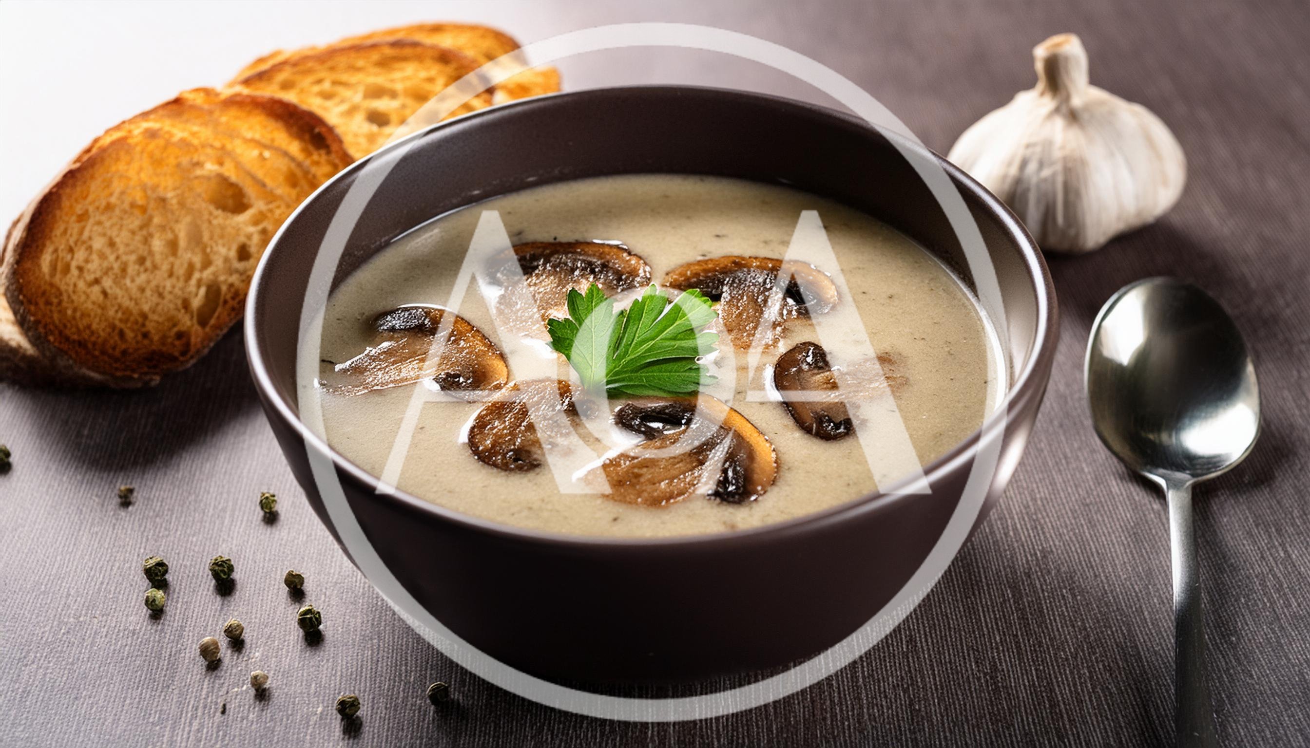 Creamy Mushroom Soup Served In A Dark Bowl