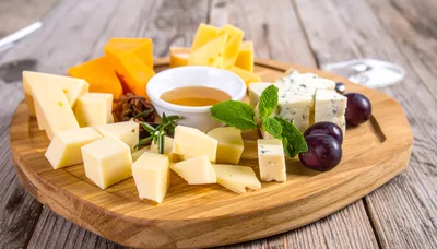 Gourmet Cheese Platter With Honey And Grapes