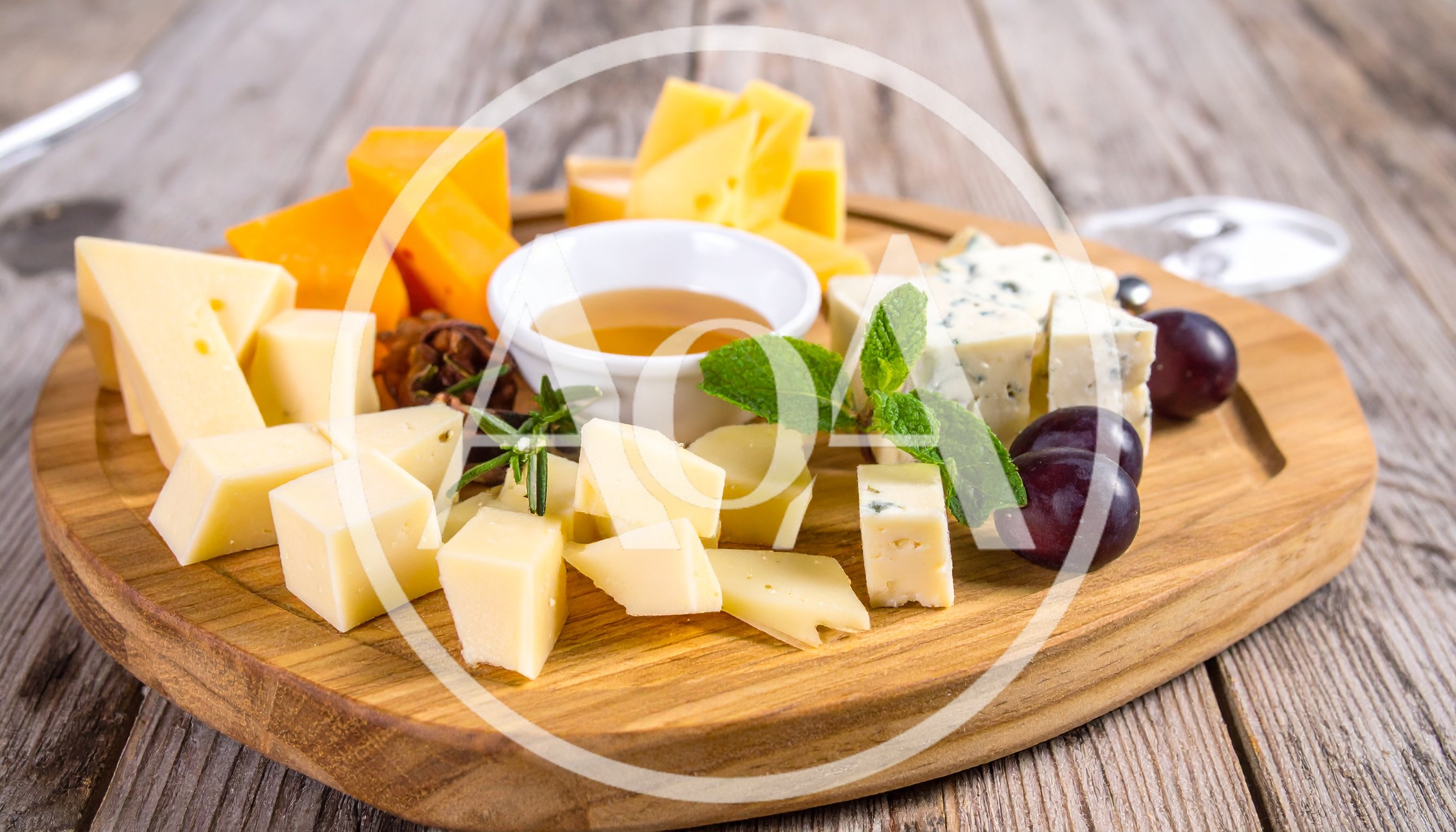 Gourmet Cheese Platter With Honey And Grapes