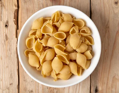 Top View Of Raw Shell Pasta In White Bowl