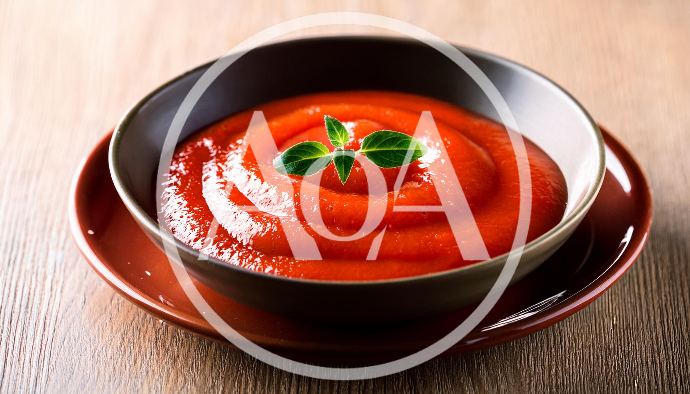 Bowl Of Tomato Soup With Fresh Basil Garnish