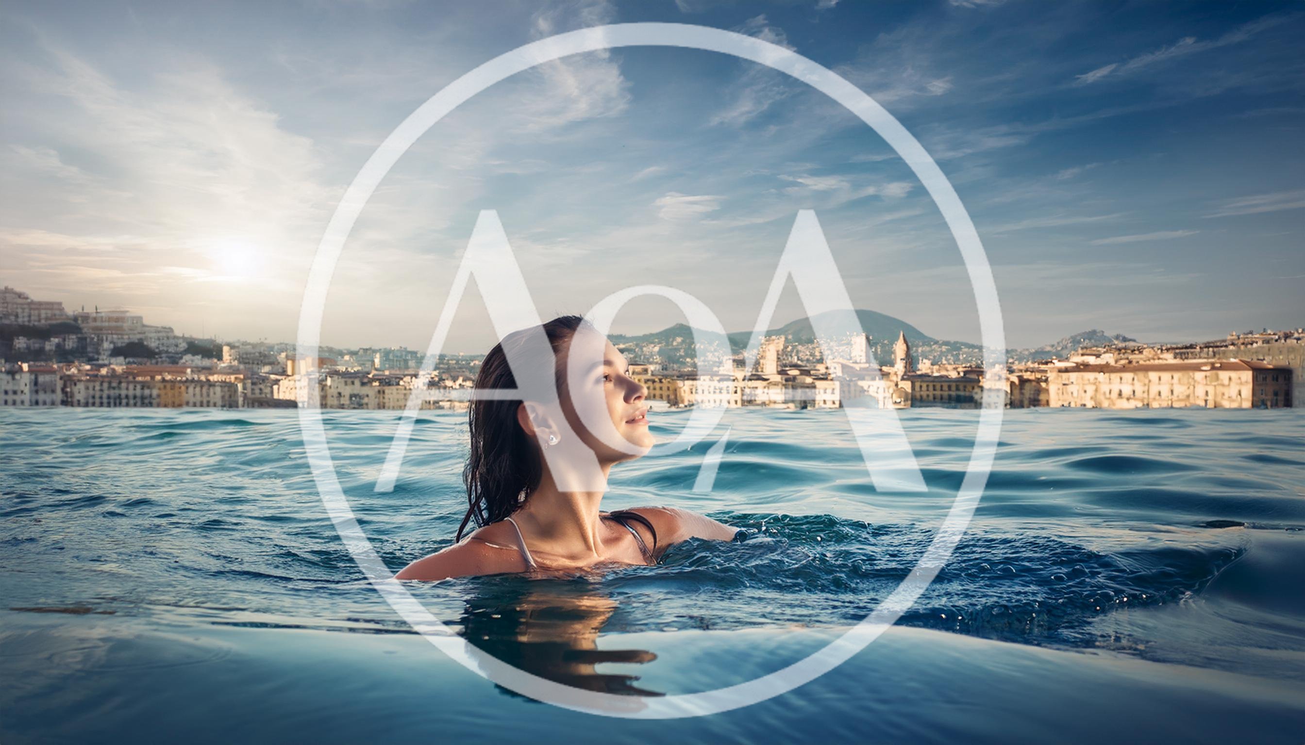 Young Woman Swimming In An Infinity Pool