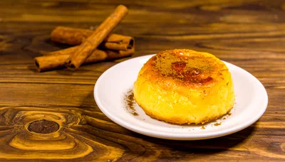 Cinnamon Topped Custard Dessert on Wooden Table