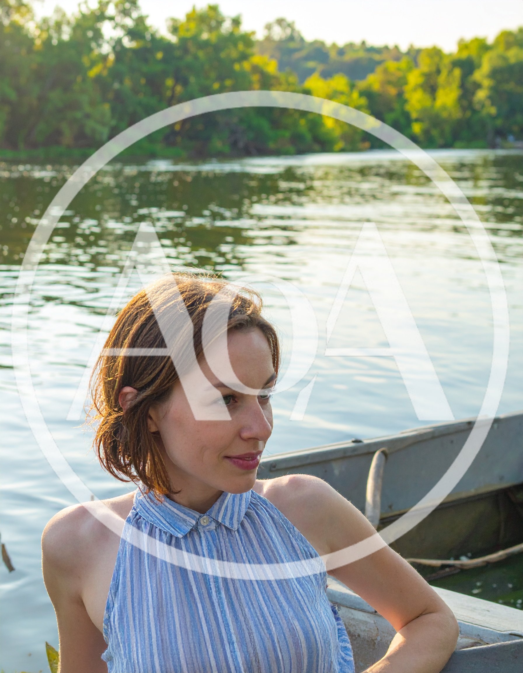 Young Woman Relaxing In A Boat On A River