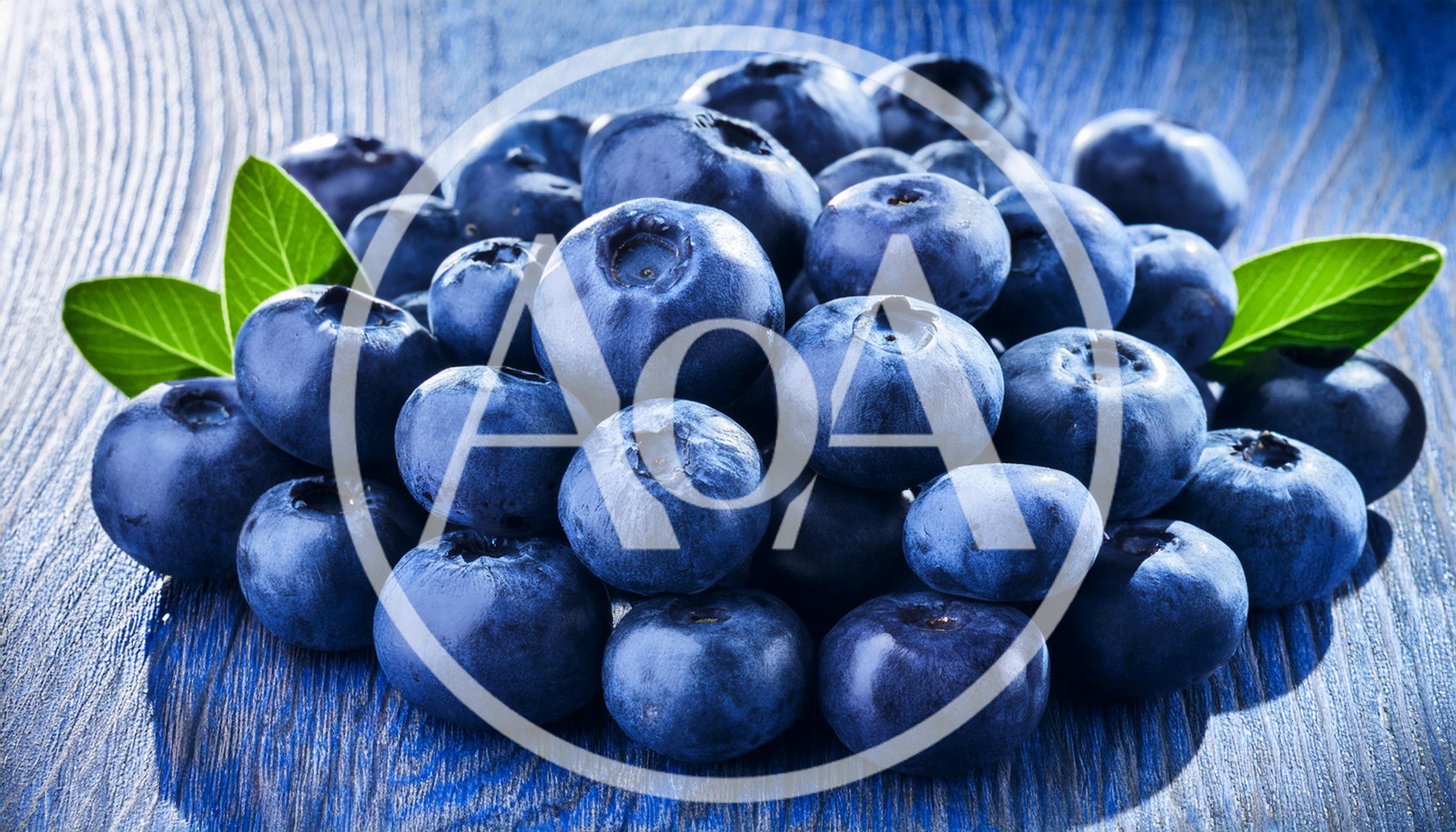 Fresh Blueberries With Green Leaves On Blue Wood