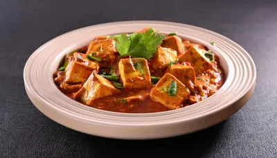Paneer Butter Masala Served In A Ceramic Bowl