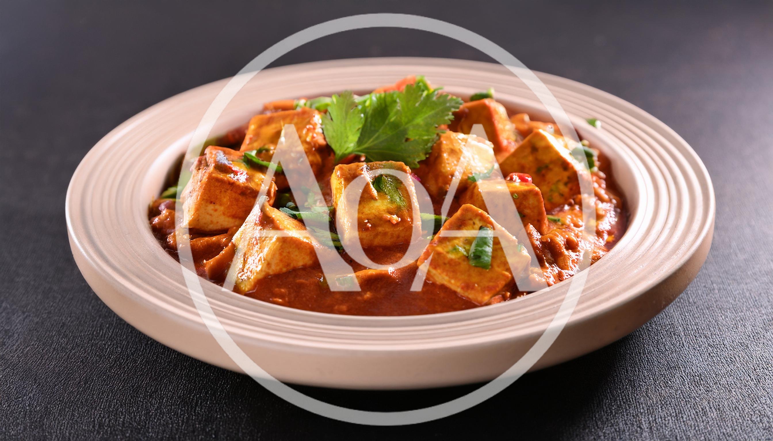 Paneer Butter Masala Served In A Ceramic Bowl