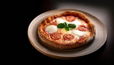 Fresh Margherita Pizza On A Rustic Ceramic Plate