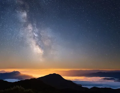 Milky Way Galaxy Over Mountain Range Above Clouds