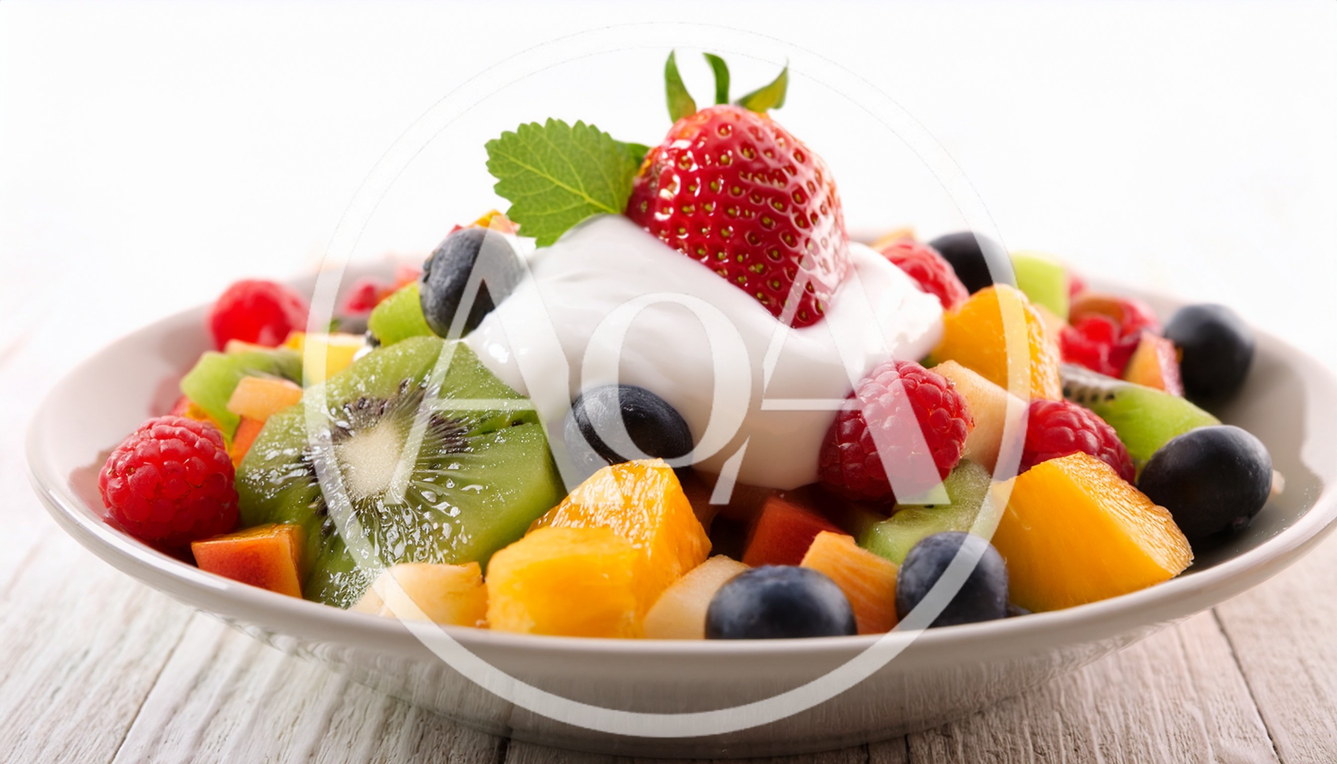 Fresh Fruit Salad With Cream And Mint Garnish