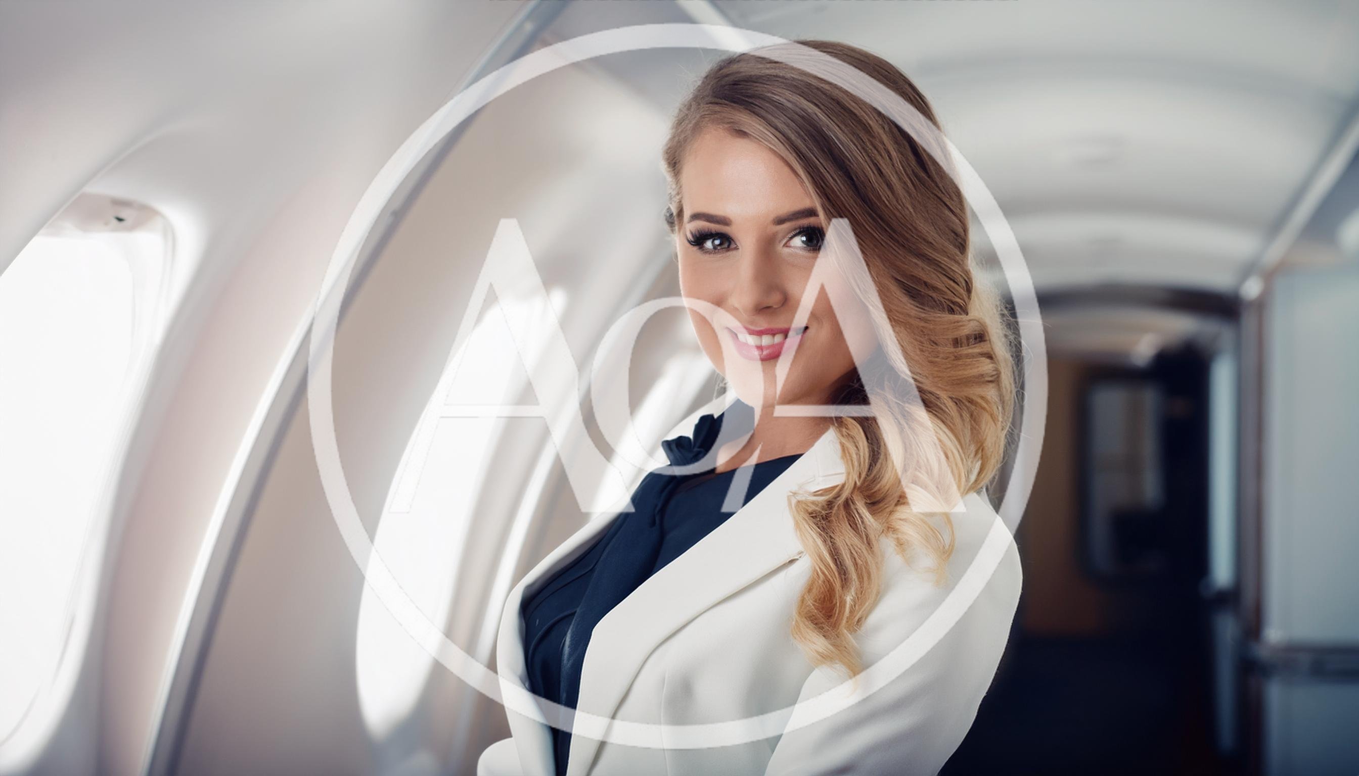 Professional Flight Attendant Smiling Inside Private Jet Cabin