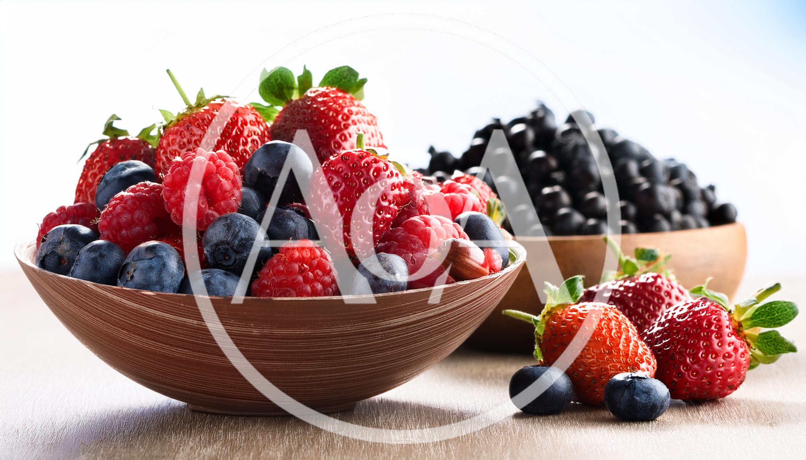 Fresh Berries In Wooden Bowls On A Table