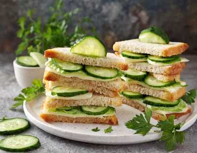 Stacked Cucumber And Cheese Sandwiches On A Plate