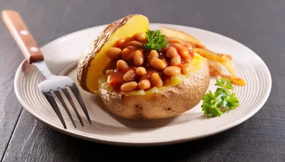 Baked Potato Topped With Beans On A Plate