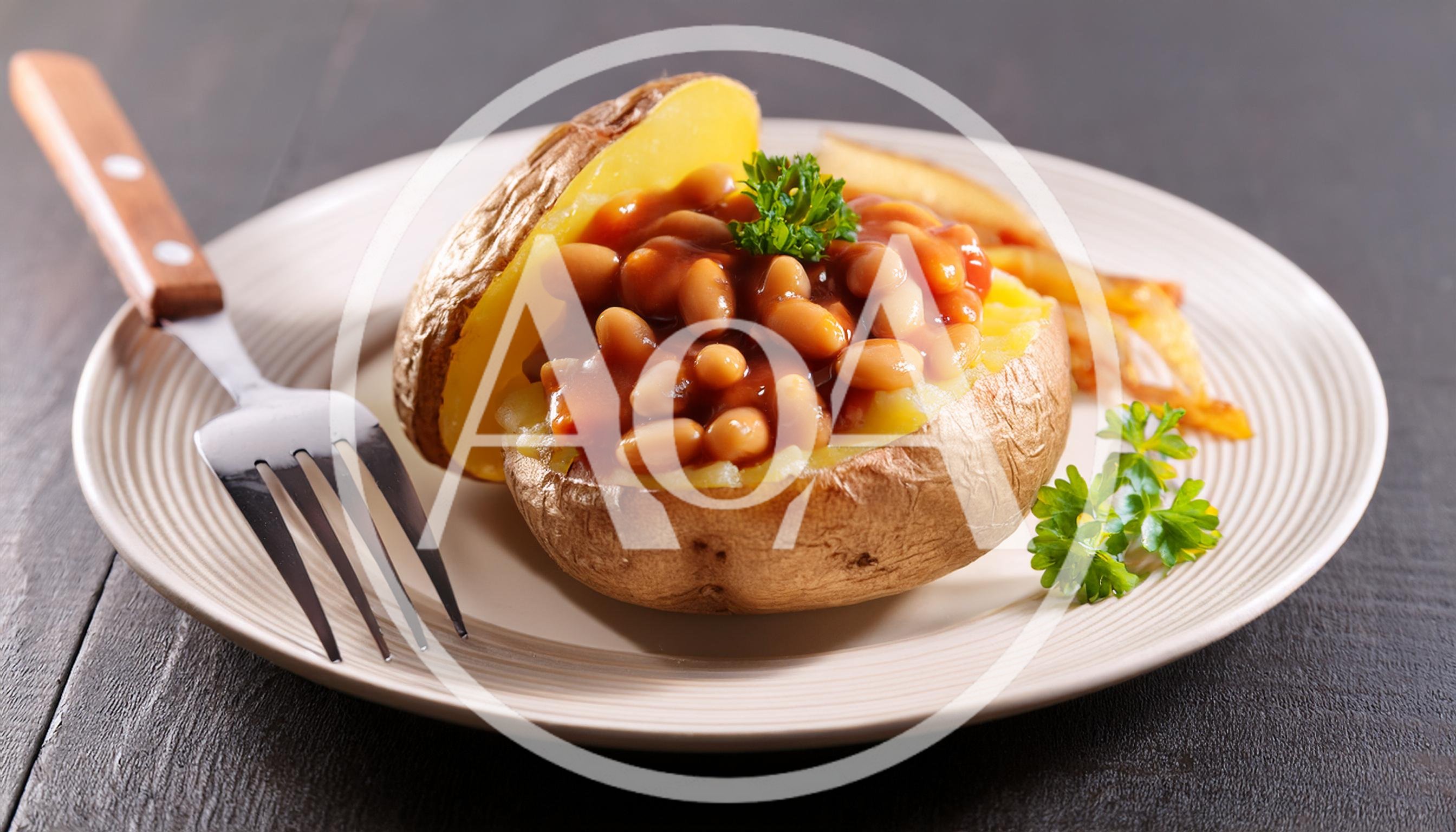 Baked Potato Topped With Beans On A Plate