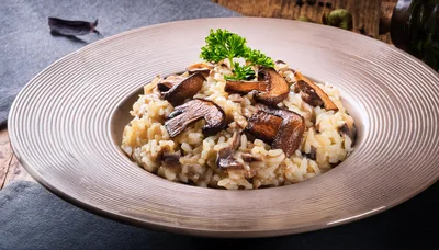 Mushroom Risotto Served In A Shallow Bowl