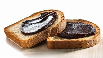 Two Slices Of Toasted Bread With Dark Chocolate Spread