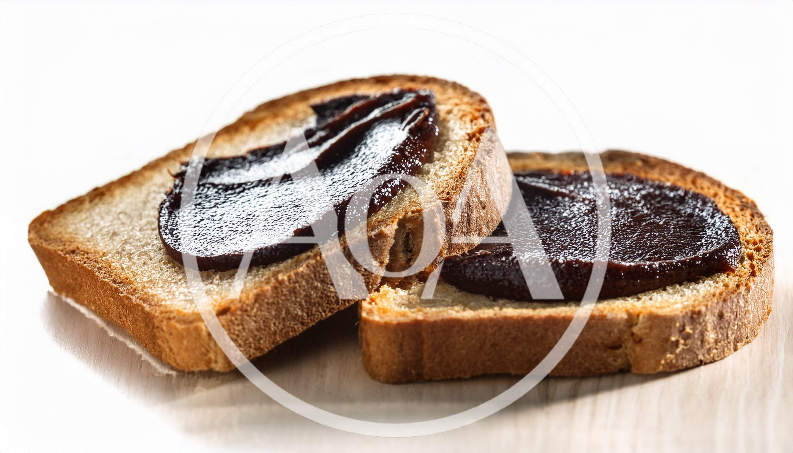 Two Slices Of Toasted Bread With Dark Chocolate Spread