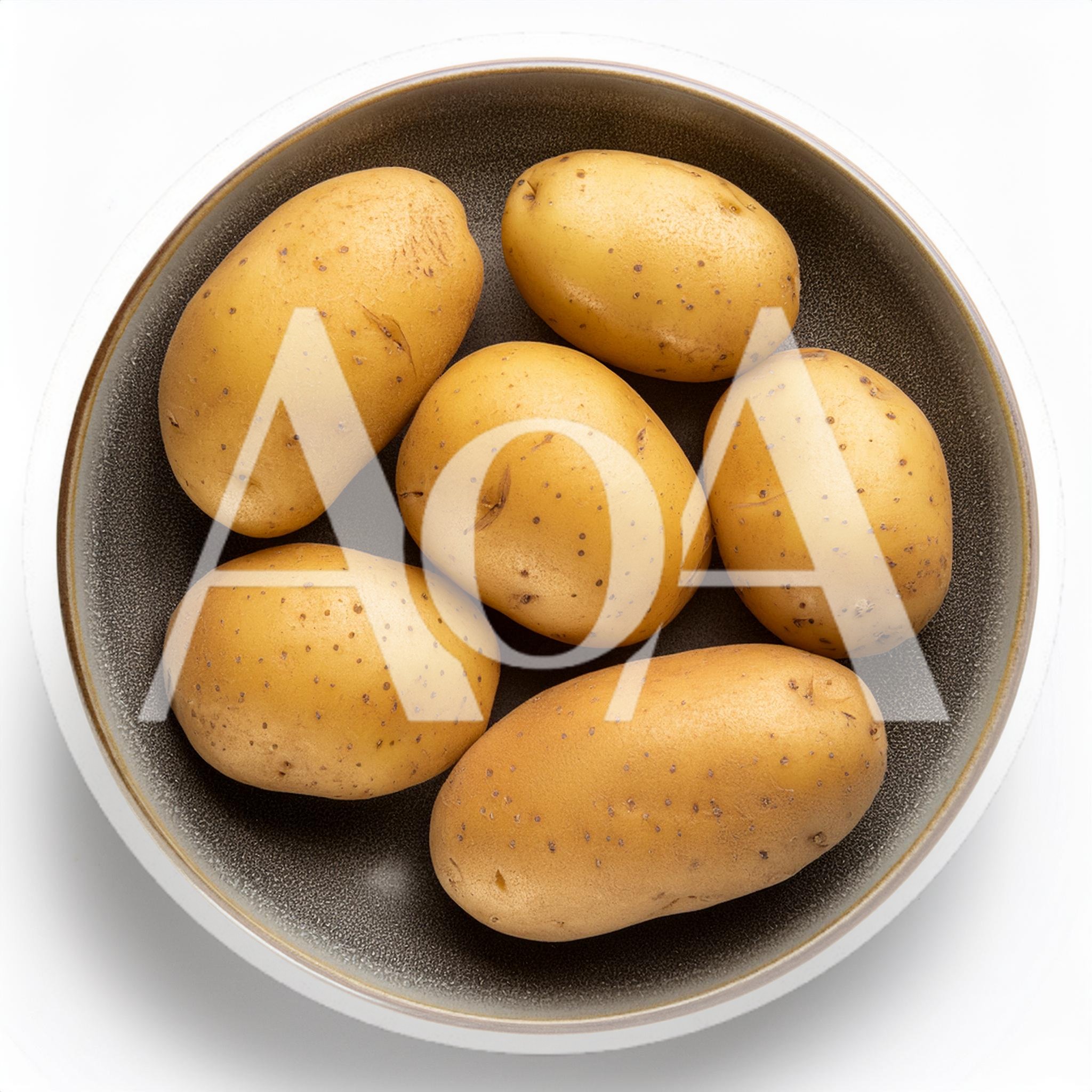 Six Raw Potatoes In A Dark Ceramic Bowl