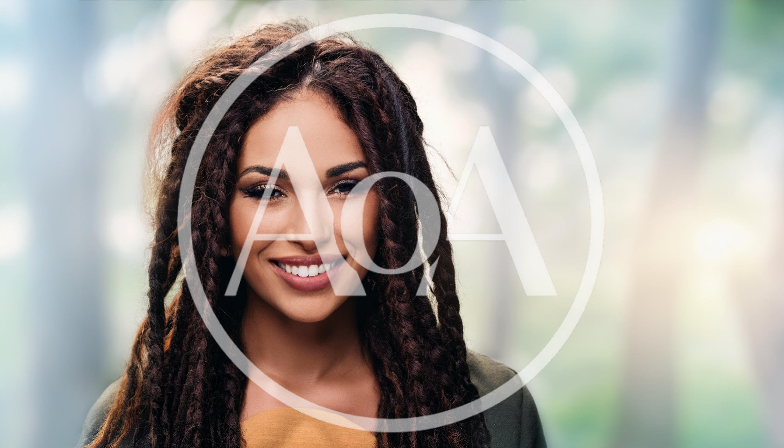 Portrait Of A Smiling Woman With Dreadlocks