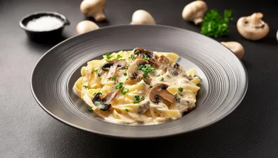 Creamy Mushroom Fettuccine Pasta in a Dark Bowl