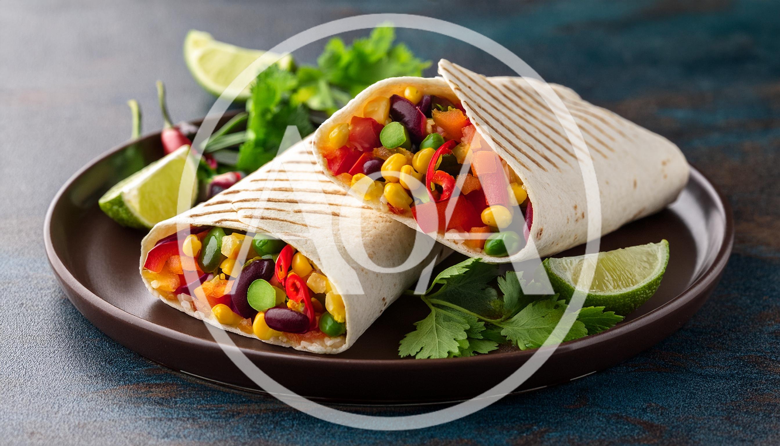 Two Halves Of A Vegetable Burrito On A Plate