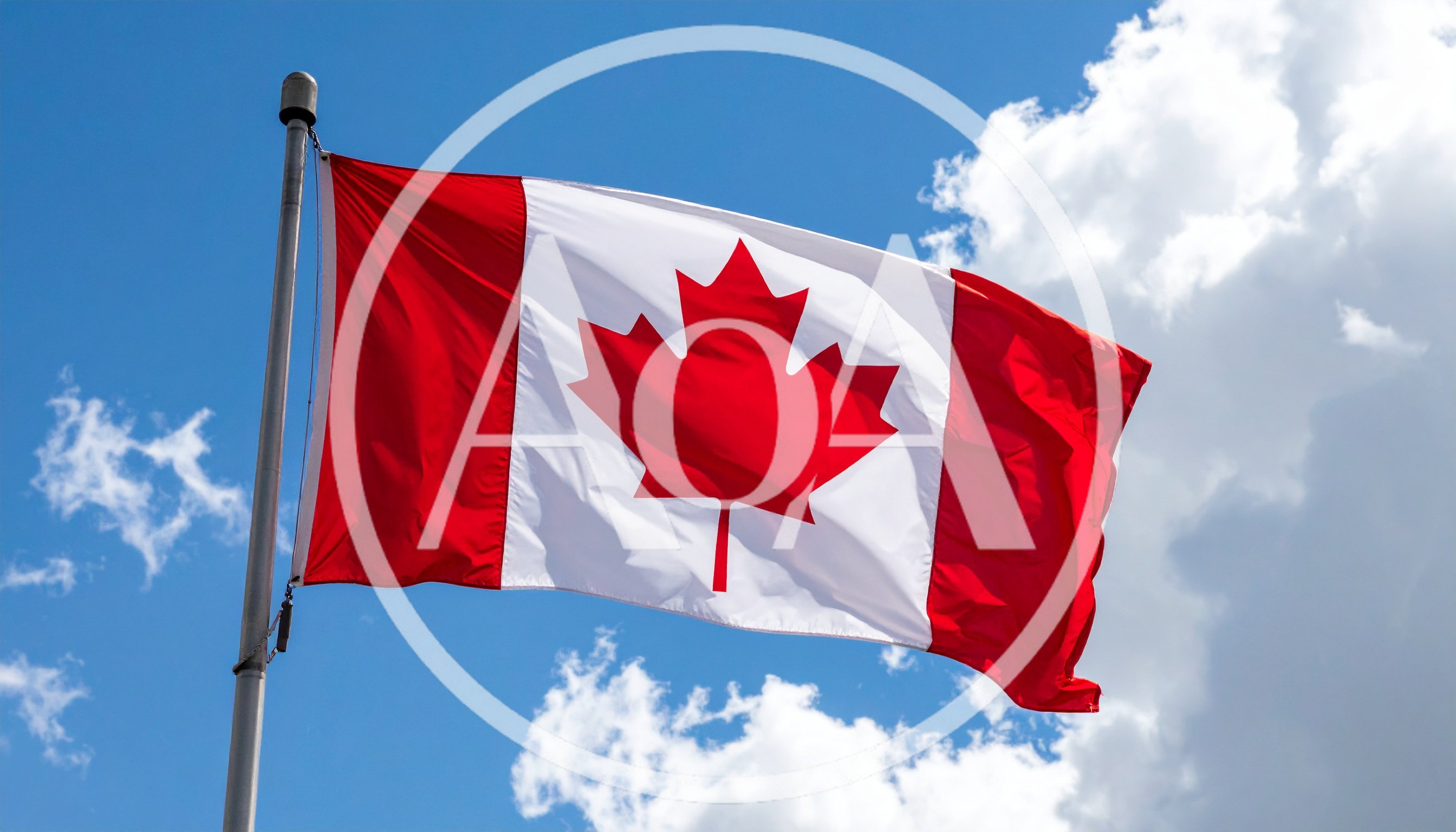 Canadian Flag Waving Against A Blue Sky