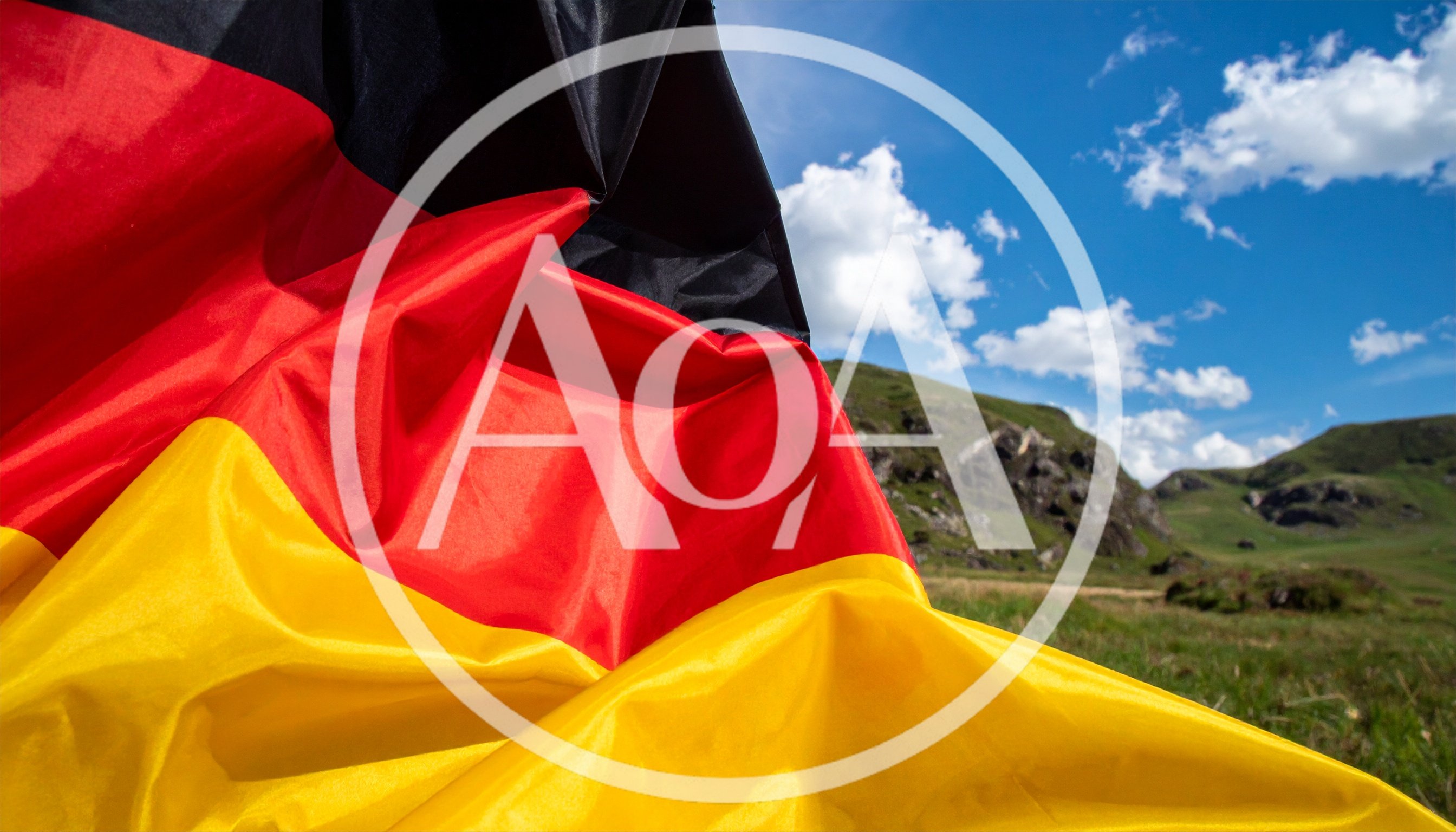 German Flag Waving Against A Mountain Landscape