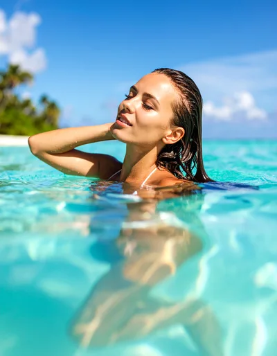 Beautiful Woman Relaxing In Tropical Ocean Waters