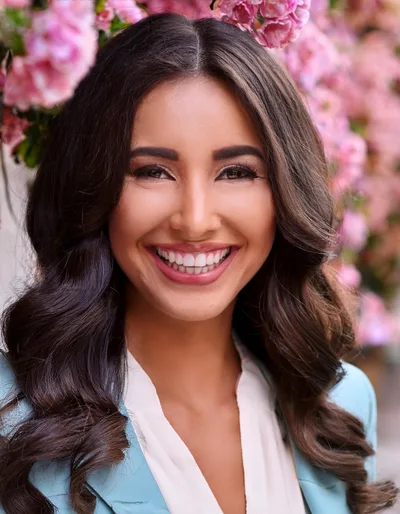 Portrait Of A Smiling Woman With Long Wavy Hair