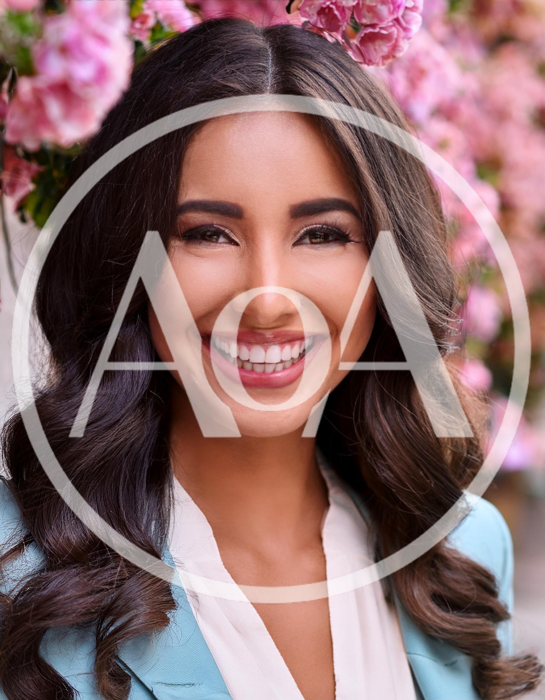 Portrait Of A Smiling Woman With Long Wavy Hair