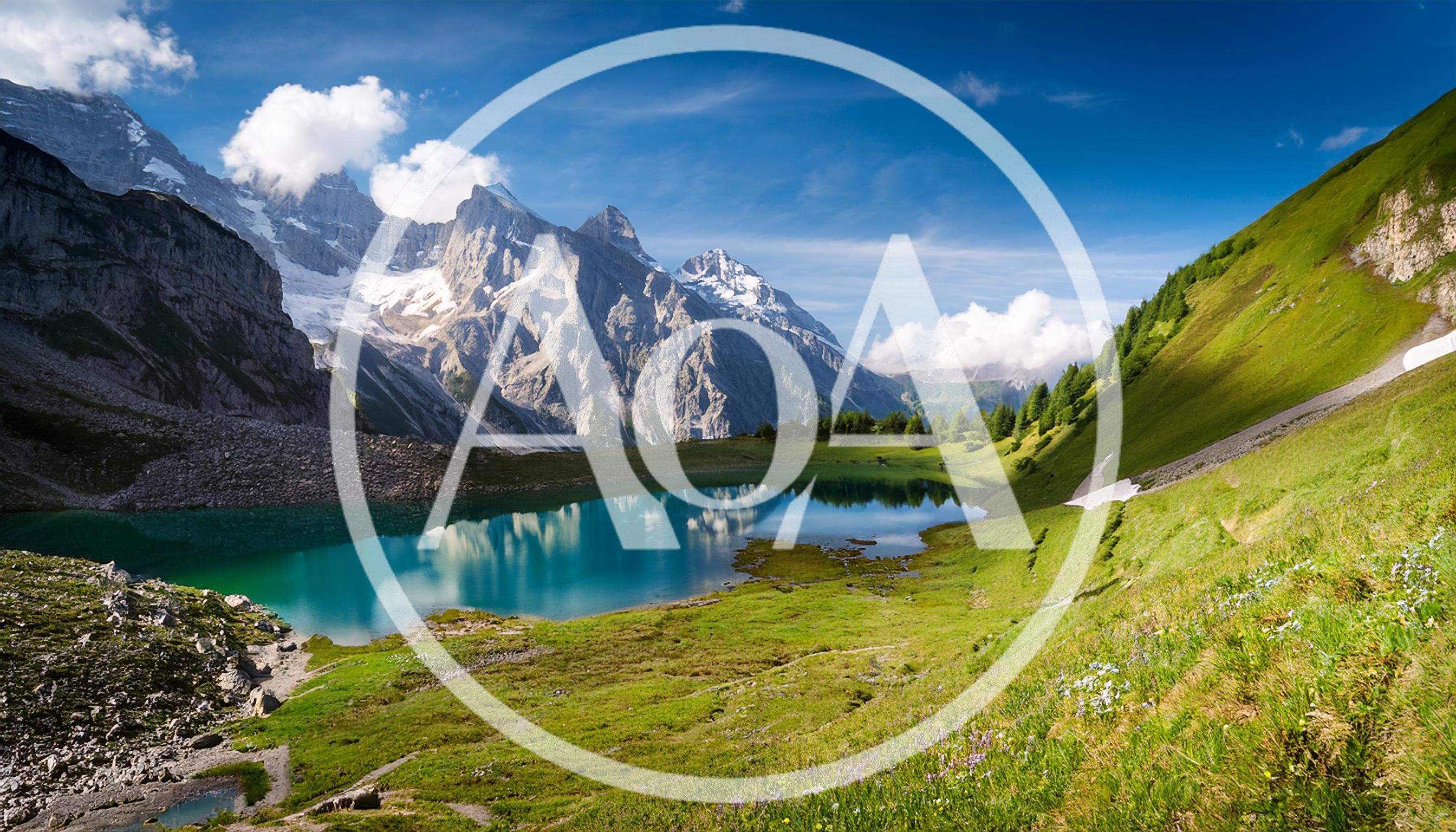 Alpine Lake Surrounded By Snow Capped Mountains