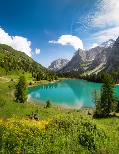 Stunning Turquoise Alpine Lake Surrounded By Lush Mountains