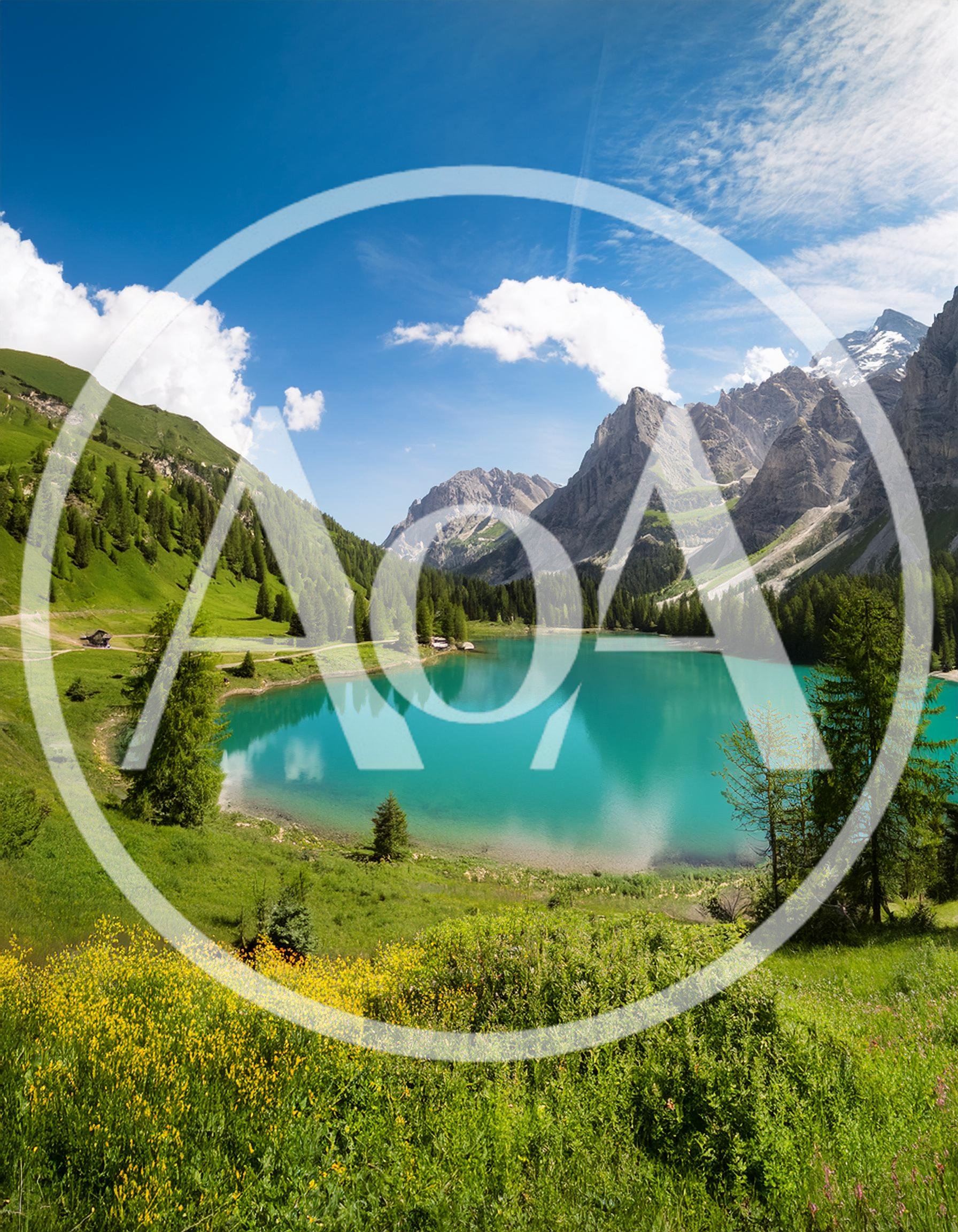 Stunning Turquoise Alpine Lake Surrounded By Lush Mountains