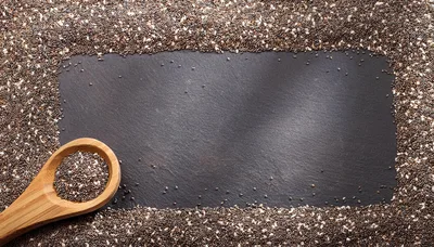 Chia Seeds On A Slate Background With Wooden Spoon